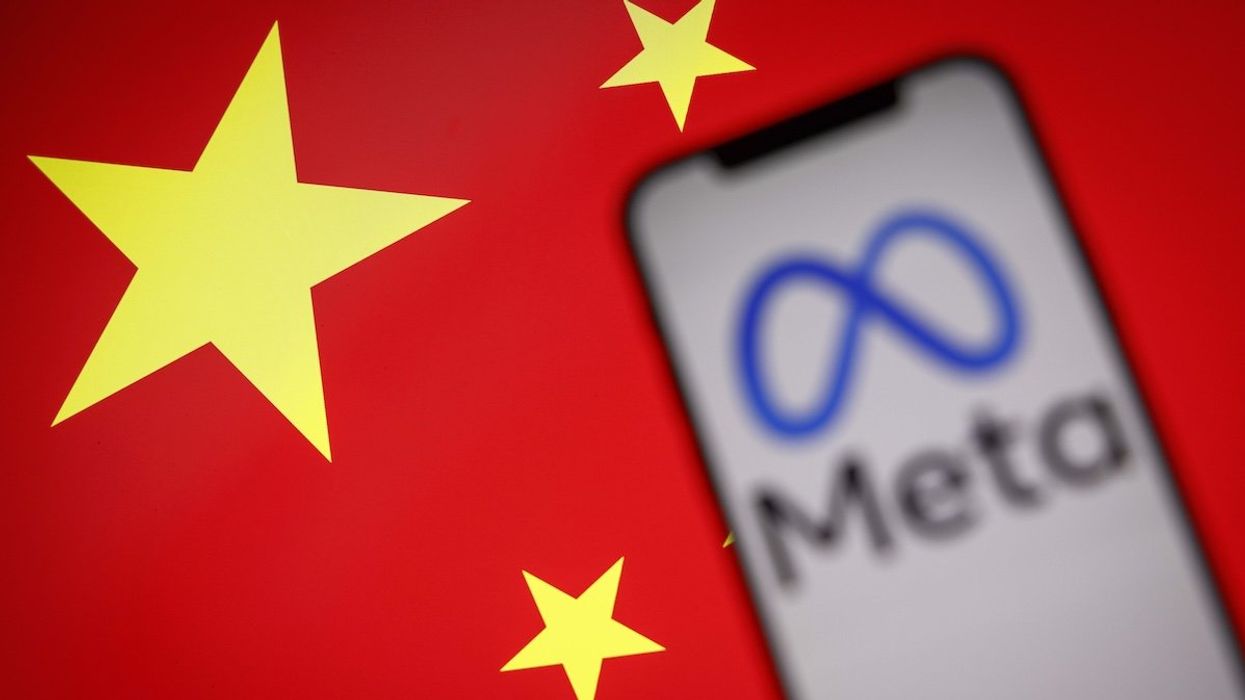 The Meta logo is seen on a mobile phone with the Chinese flag in the background in this photo illustration.