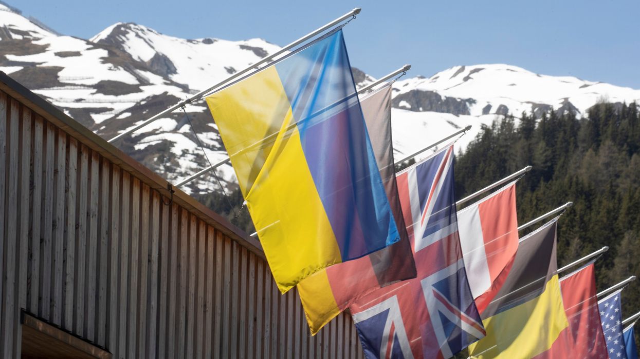 The national flag of Ukraine flies along with other countries' flags at the congress center for the 2022 edition of the World Economic Forum.