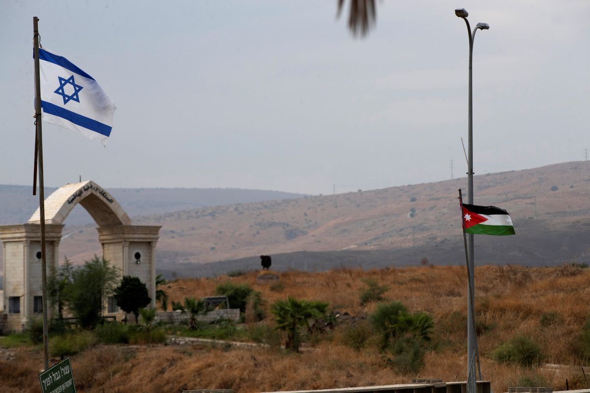 The national flags of Jordan and Israel are seen from the Israeli side of the border.