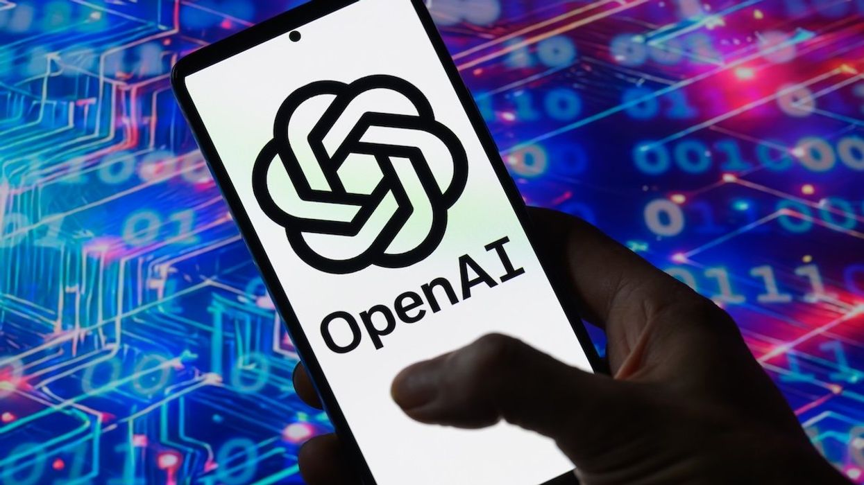 The OpenAi logo is displayed on a mobile screen in this photo illustration.