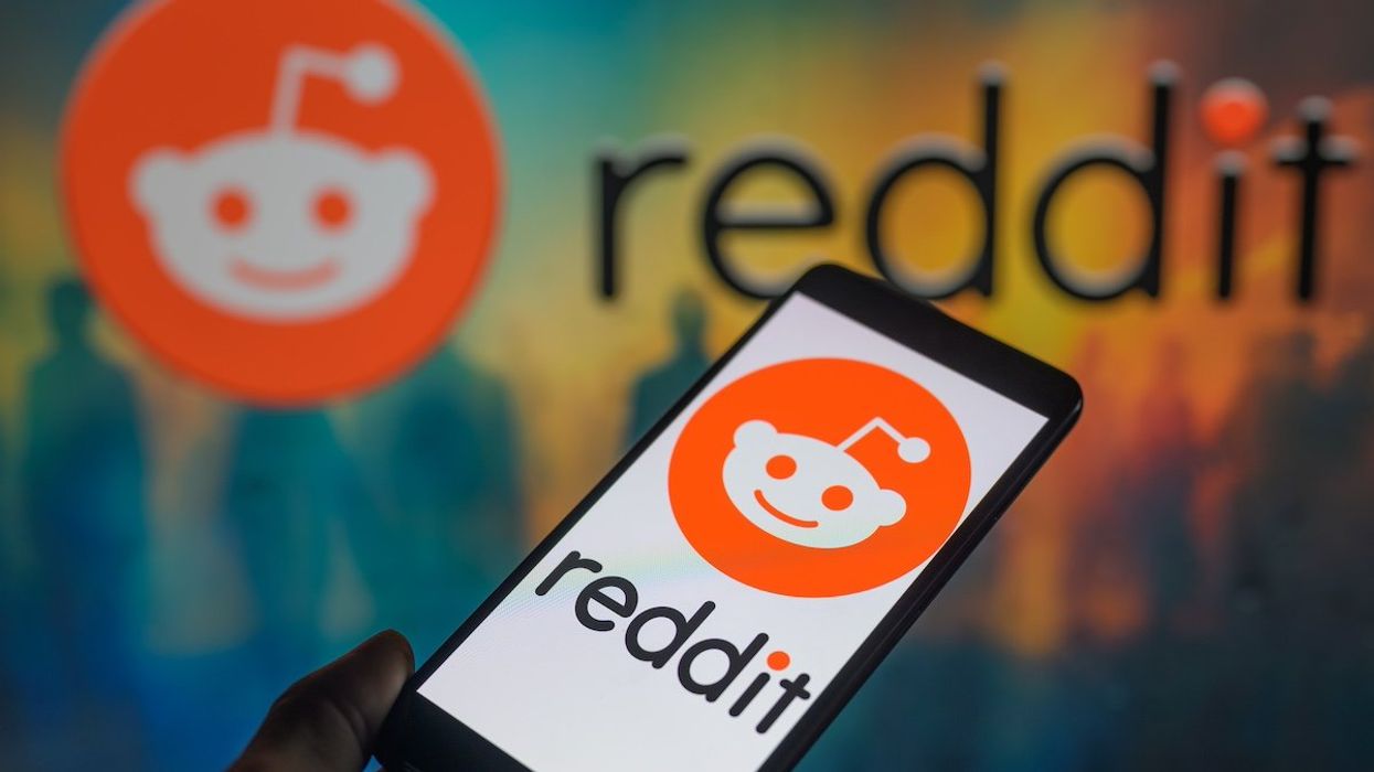 The Reddit logo is displayed on a smartphone with Reddit visible in the background in this photo illustration. Taken in Brussels, Belgium. On March 17, 2024.