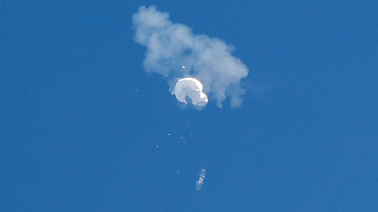 The suspected Chinese spy balloon drifts to the ocean after being shot down off the coast in Surfside Beach, South Carolina.