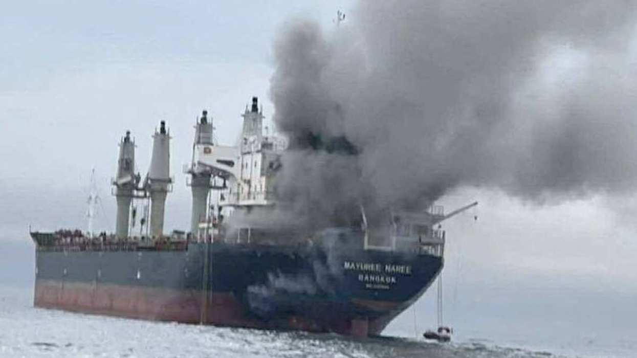 The Thailand-flagged cargo ship Mayuree Naree engulfed in black smoke in the Strait of Hormuz, March 11, 2026.