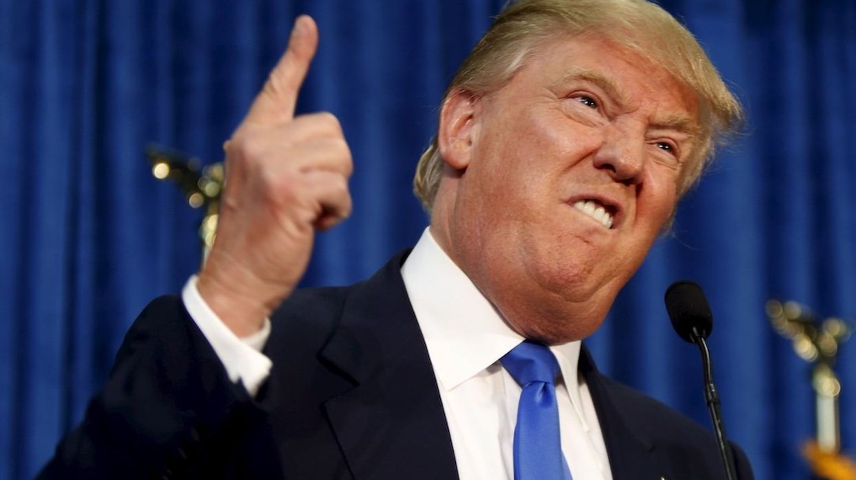 Then Republican presidential candidate Donald Trump gestures and declares "You're fired!" at a rally in New Hampshire in 2015.