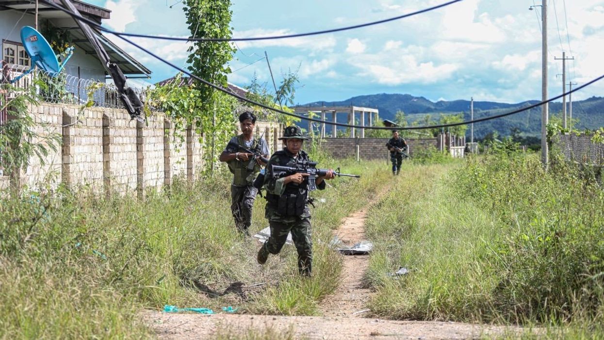 This photo taken on September 12, 2022 shows the members of the Nay Pyi Taw People Defense Force running at the frontline frontline in Mobyae, Southern Shan State, Myanmar.