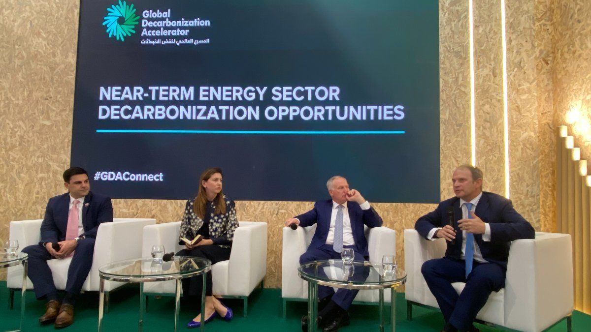 Three men and a woman at the Global Decarbonization Accelerator panel