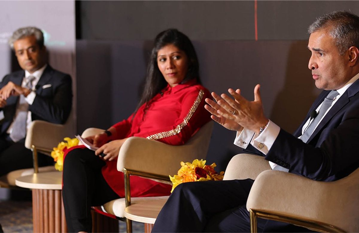 Three panelists listening as one talks