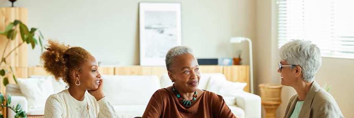 Three women sitting and talking around a table