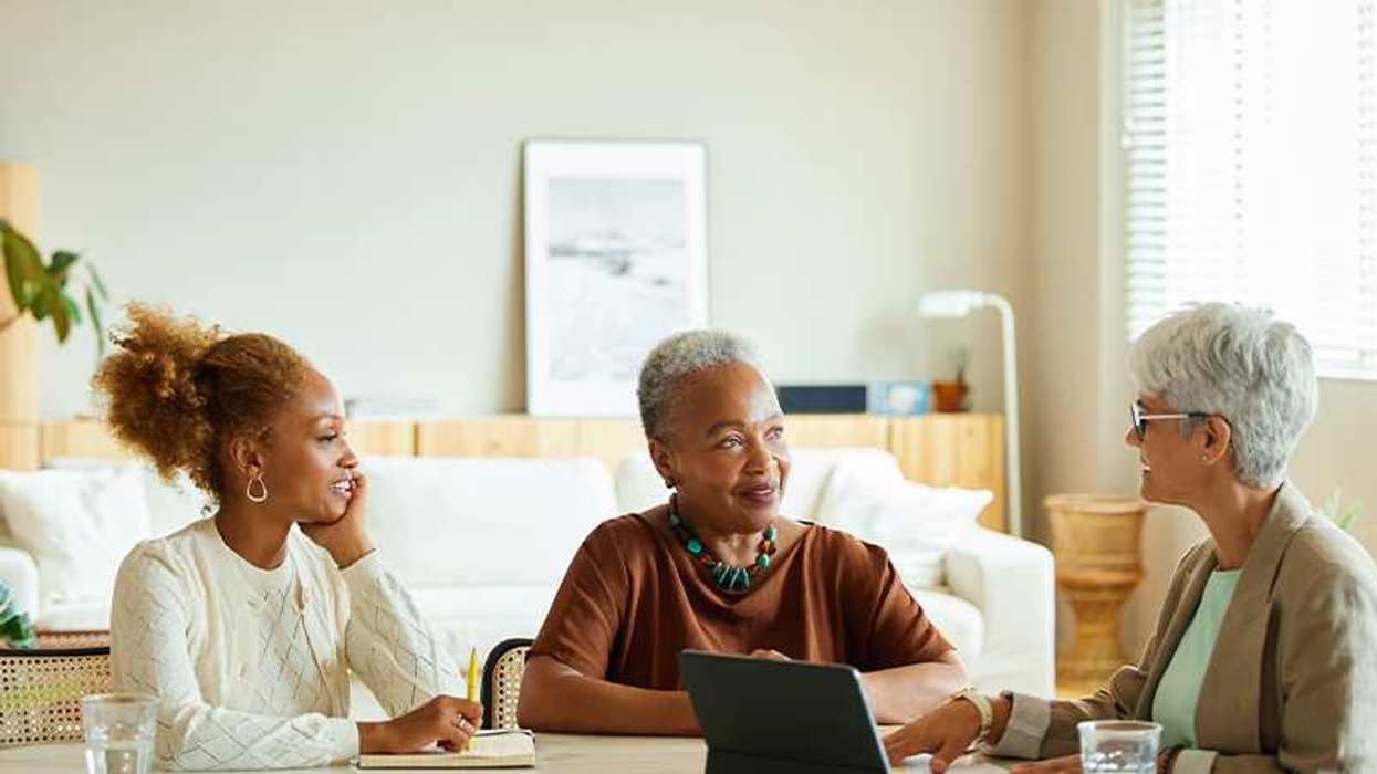 Three women sitting and talking around a table