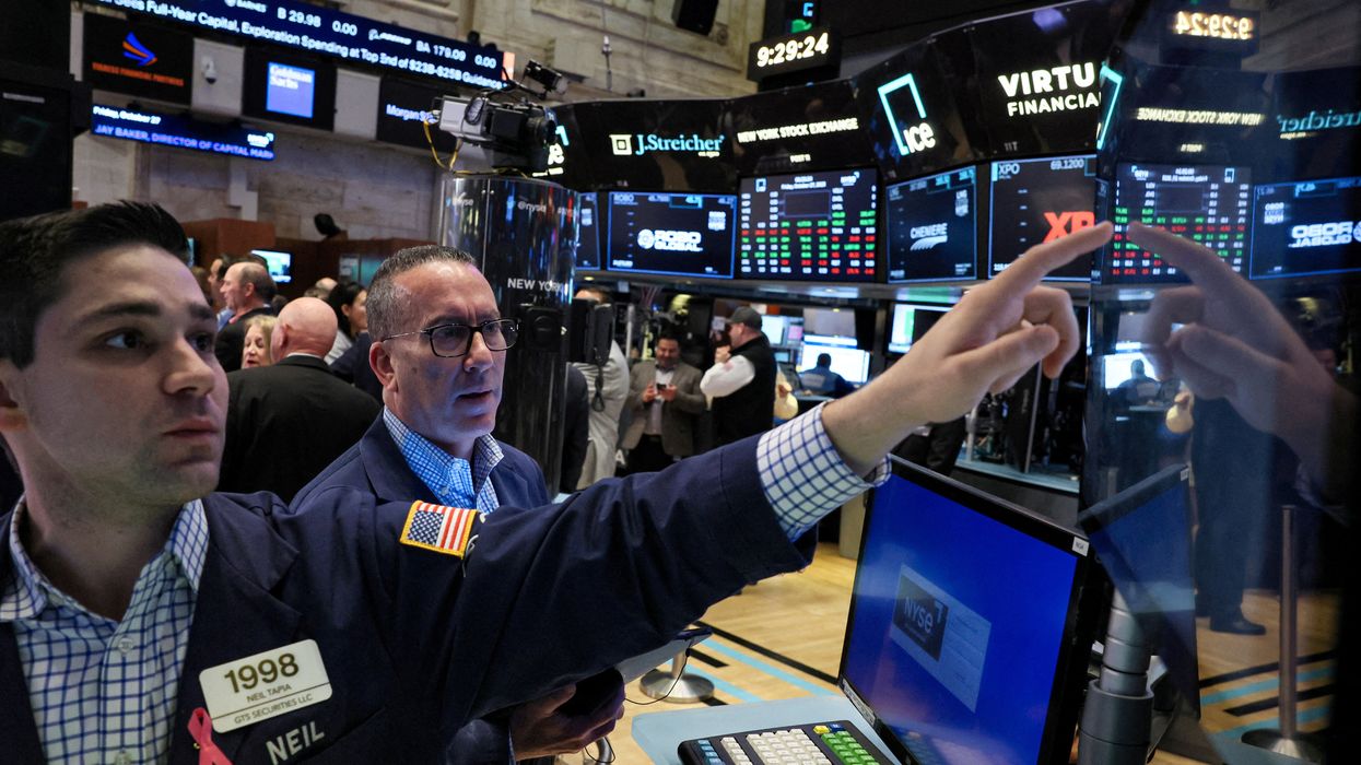 Traders work on the floor at the New York Stock Exchange in New York City.