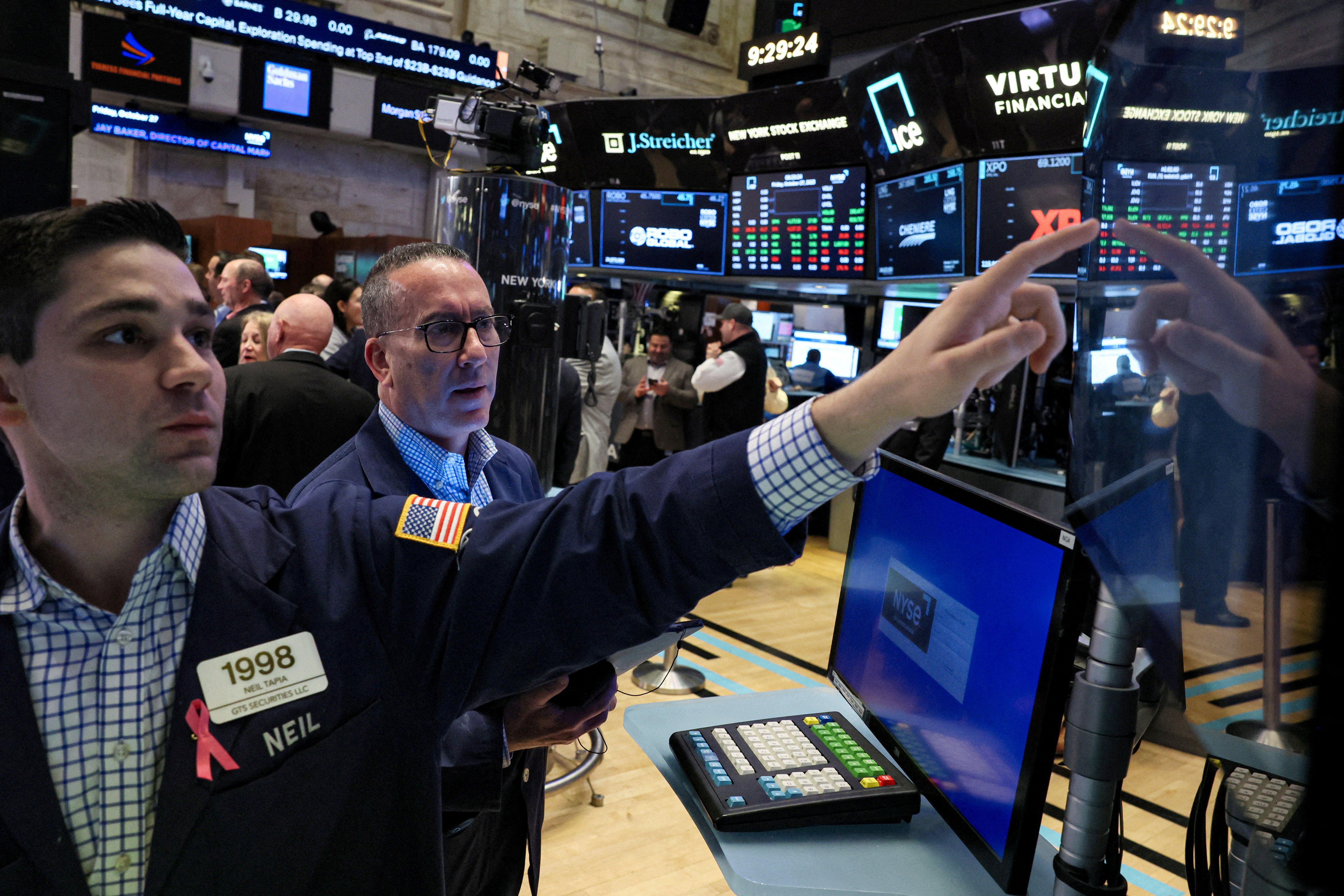 Traders work on the floor at the New York Stock Exchange in New York City.