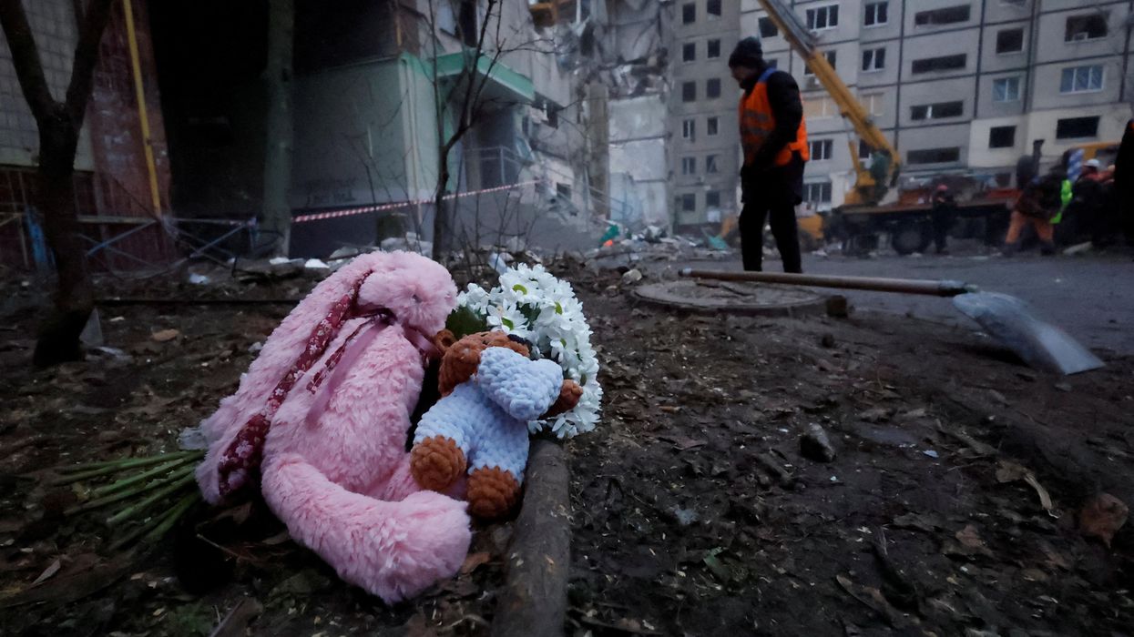 Tributes are left at the site where an apartment block was heavily damaged by a Russian missile strike in Dnipro, Ukraine.