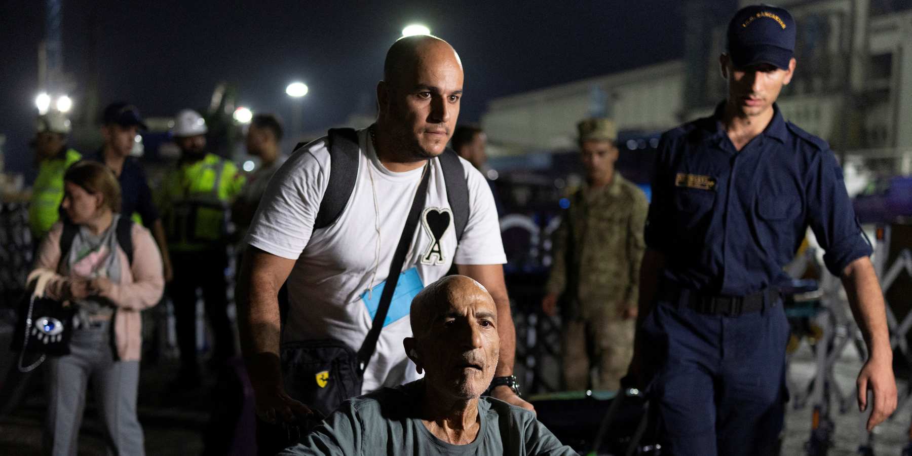 Turkish citizens disembark naval ship TCG Bayraktar carrying people evacuated from Lebanon upon their arrival at a port in Turkey's Mediterranean coastal province of Mersin, Turkey, October 10, 2024.