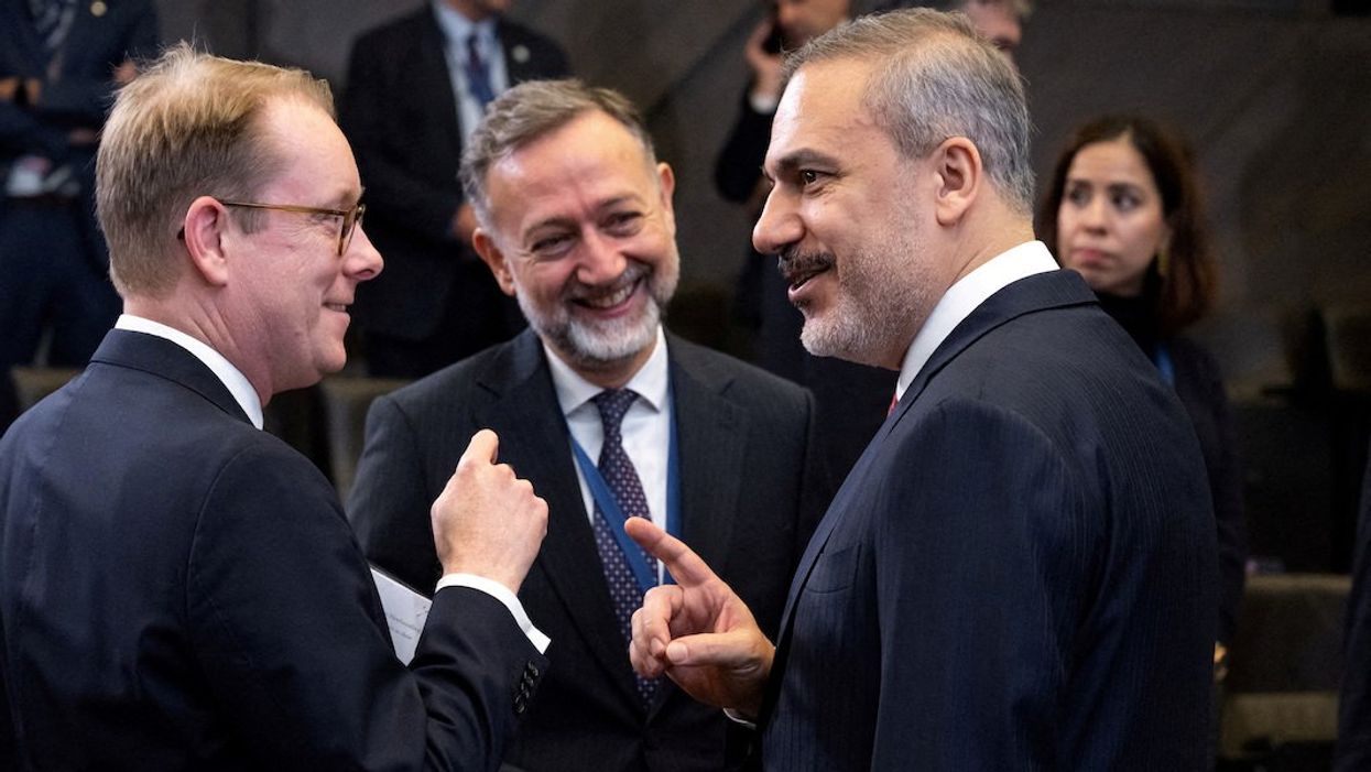 Turkish Foreign Minister Hakan Fidan speaks with Swedish Foreign Minister Tobias Billstrom ahead of the NATO Foreign Ministers meeting at NATO Headquarters in Brussels, Belgium, November 28, 2023.