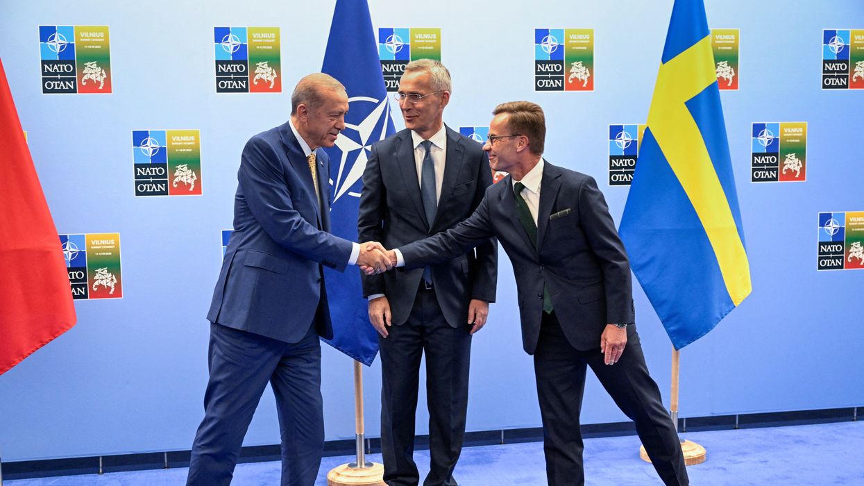 Turkish President Recep Tayyip Erdogan and Swedish Prime Minister Ulf Kristersson shake hands next to NATO Secretary-General Jens Stoltenberg in Vilnius, Lithuania.