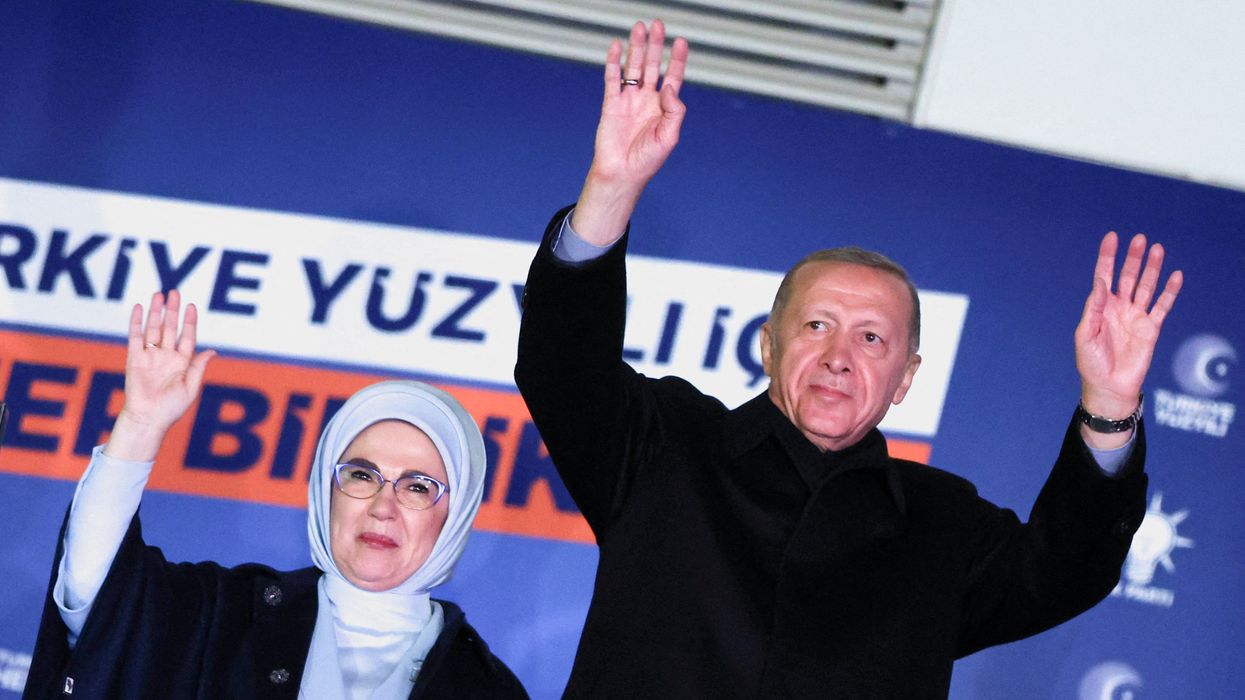 Turkish President Tayyip Erdogan, accompanied by his wife Ermine Erdogan, greets supporters at the AK Party headquarters in Ankara, Turkey.