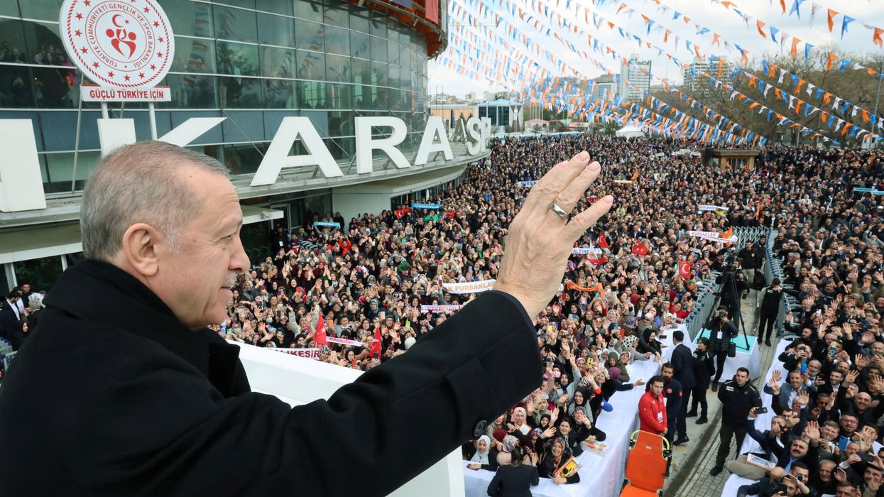 Turkish President Tayyip Erdogan greets the crowd before a meeting of his ruling AK Party to announce the party's election manifesto ahead of the May 14 elections, in Ankara, Turkey April 11, 2023.