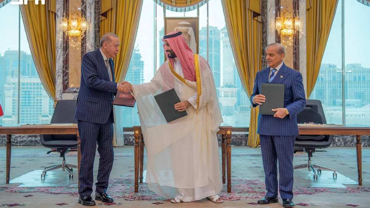 Turkish President Tayyip Erdogan shakes hands with Saudi Crown Prince Mohammed bin Salman, next to Pakistan's Prime Minister Shehbaz Sharif.