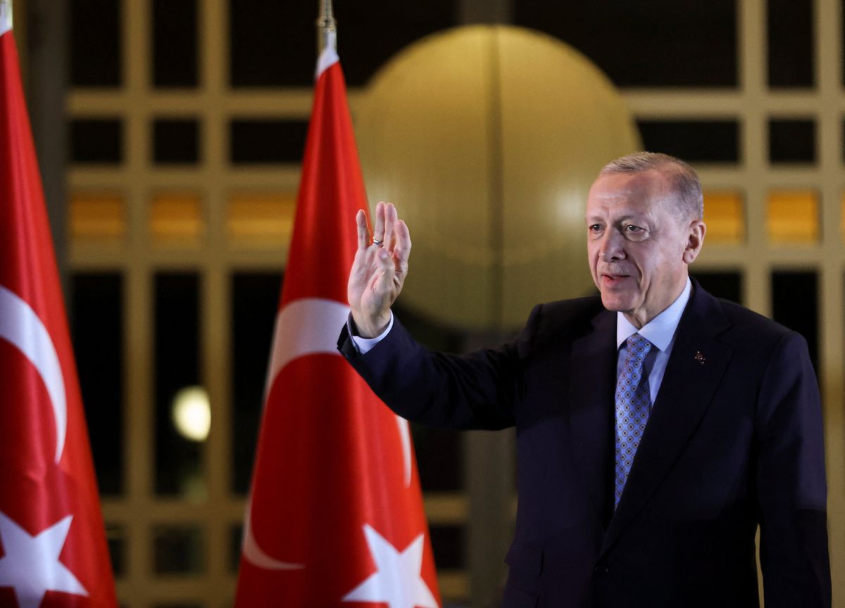 Turkish President Tayyip Erdogan waves as he addresses his supporters in Ankara following his victory in the second round of the presidential election.