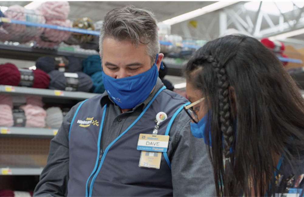 Two masked Walmart employees in uniform