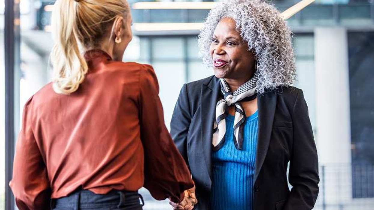 Two women shaking hands
