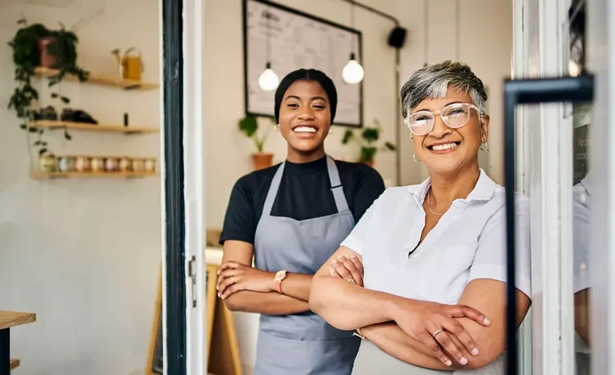 Two women smiling and standing together