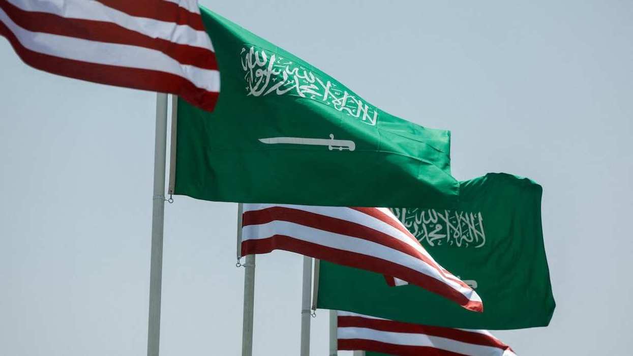 U.S. and Saudi flags flutter along a highway of Riyadh