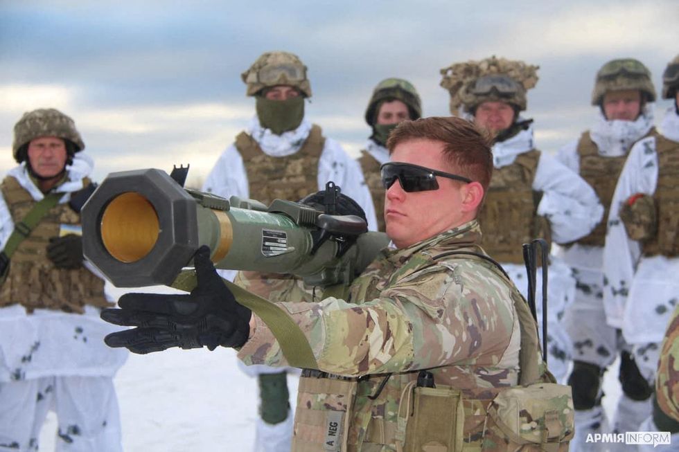 U.S. army instructor from the Joint Multinational Training Group trains Ukrainian service members to operate with M141 Bunker Defeat Munition (SMAW-D) grenade launcher, supplied by the United States, at a shooting range in Lviv Region, Ukraine, in this handout picture released January 30, 2022. 