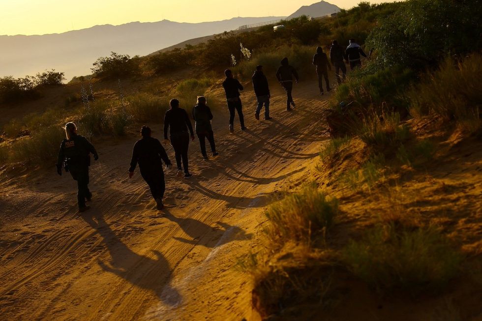 U.S. Border Patrol agents detain migrants who attempted to cross the U.S.-Mexico border undetected, in an area outside Sunland Park desert, New Mexico, U.S., June 23 2023.