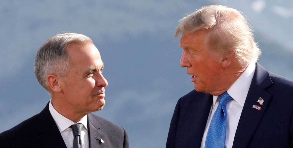 ​U.S. President Donald Trump and Canada's Prime Minister Mark Carney talk during a family photo at the G7 Summit in Kananaskis, Alberta, Canada, June 16, 2025. 