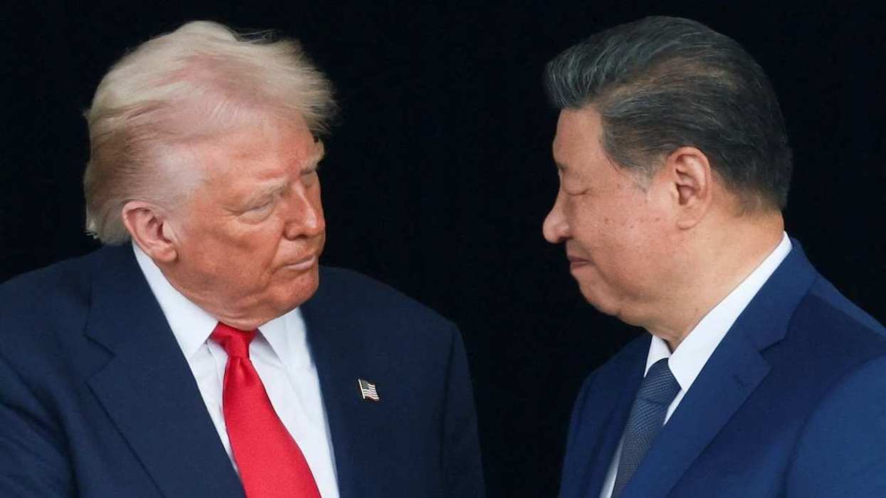 U.S. President Donald Trump and Chinese President Xi Jinping talk as they leave after a bilateral meeting.