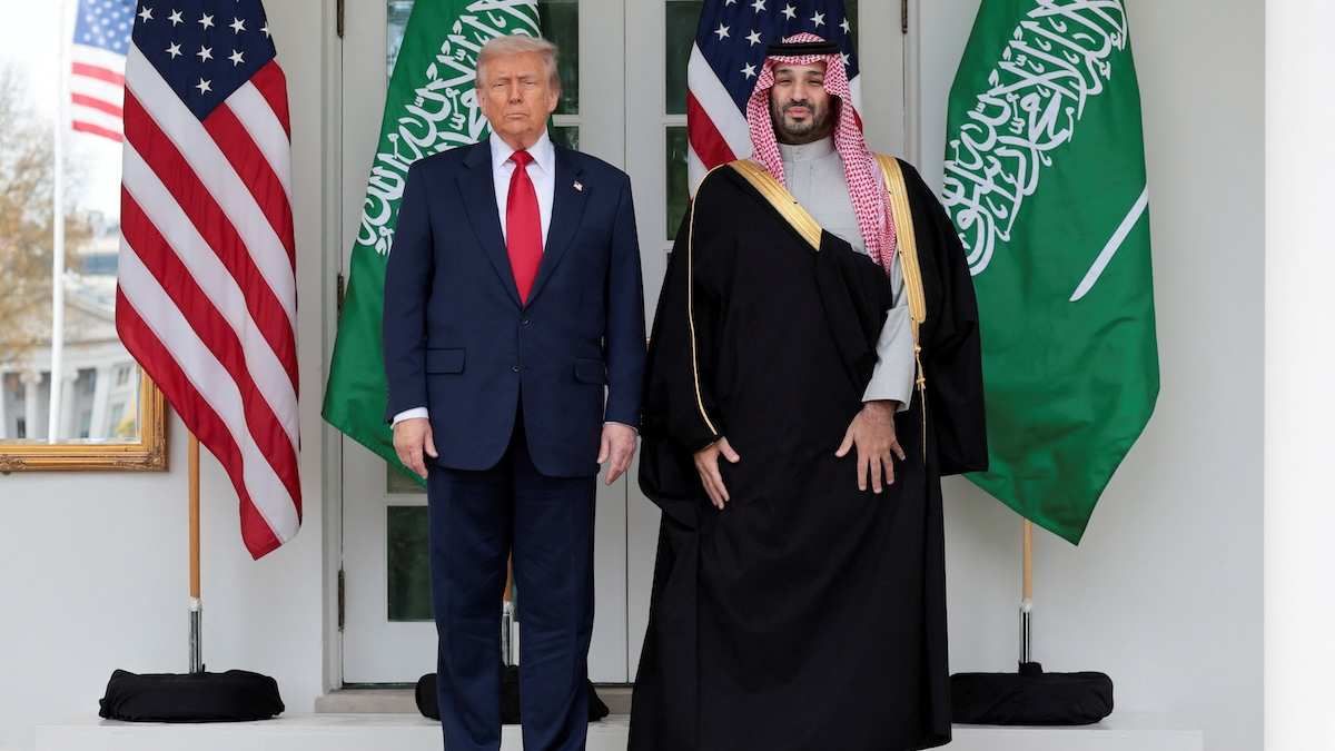 U.S. President Donald Trump and Saudi Crown Prince and Prime Minister Mohammed bin Salman stand in front of flags at the White House.