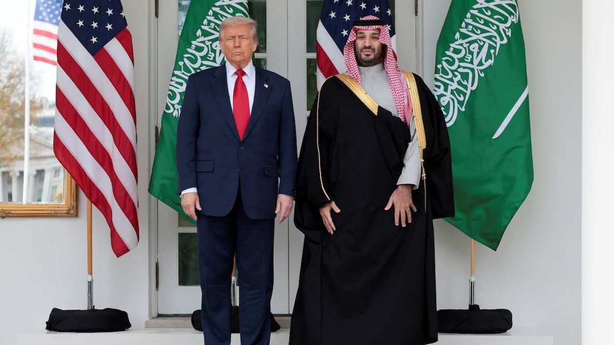 U.S. President Donald Trump and Saudi Crown Prince and Prime Minister Mohammed bin Salman stand in front of flags at the White House.