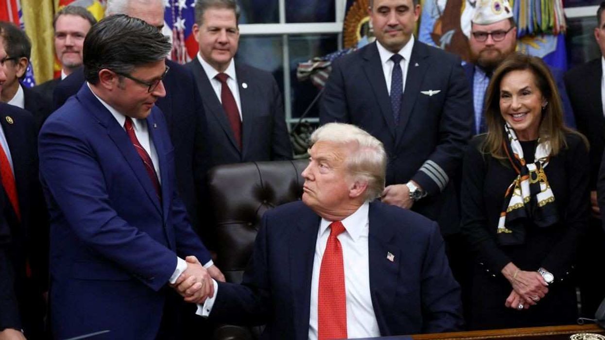 U.S. President Donald Trump shakes hands with U.S. House Speaker Mike Johnson (R-LA) after signing the funding bill to end the U.S. government shutdown, at the White House in Washington, D.C., U.S., November 12, 2025.