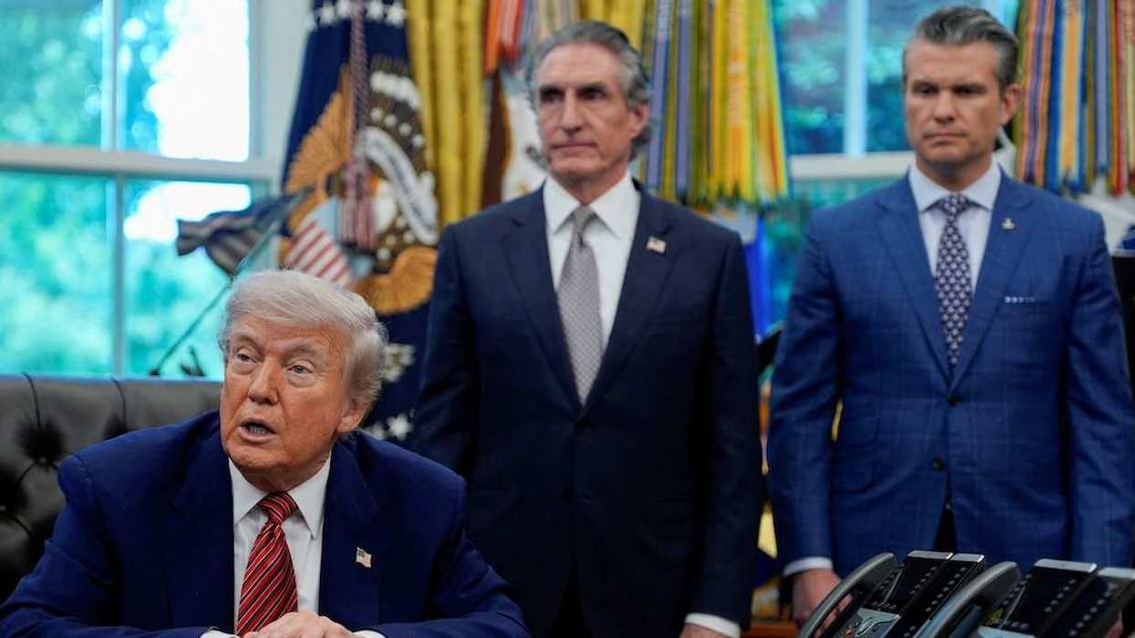 U.S. President Donald Trump speaks in the Oval Office, as U.S. Defense Secretary Pete Hegseth and Secretary of the Interior Doug Burgum look on, on the day he signs an executive order, at the White House in Washington, D.C., U.S., May 23, 2025.