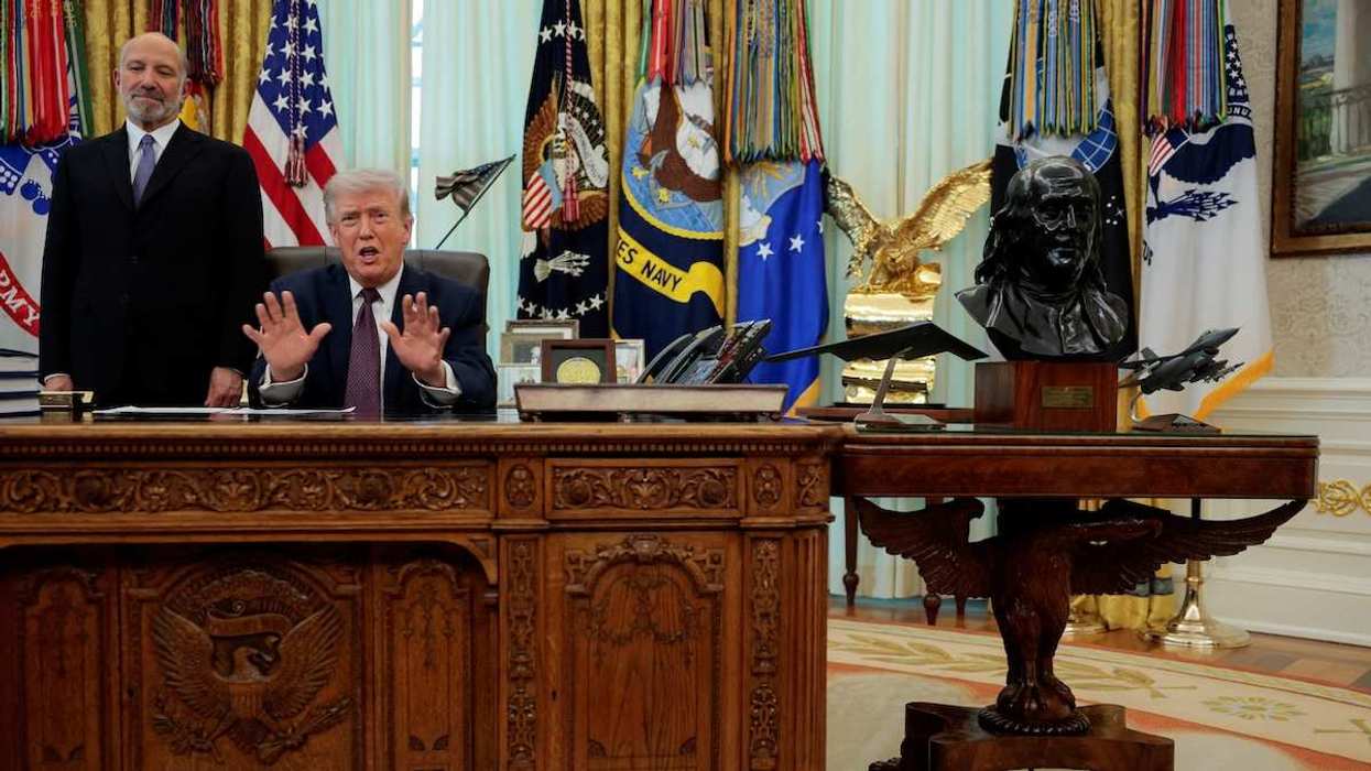 U.S. President Donald Trump speaks next to U.S. Commerce Secretary Howard Lutnick during the signing ceremony for an executive order on mail ballots, in the Oval Office of the White House in Washington, D.C., March 31, 2026.