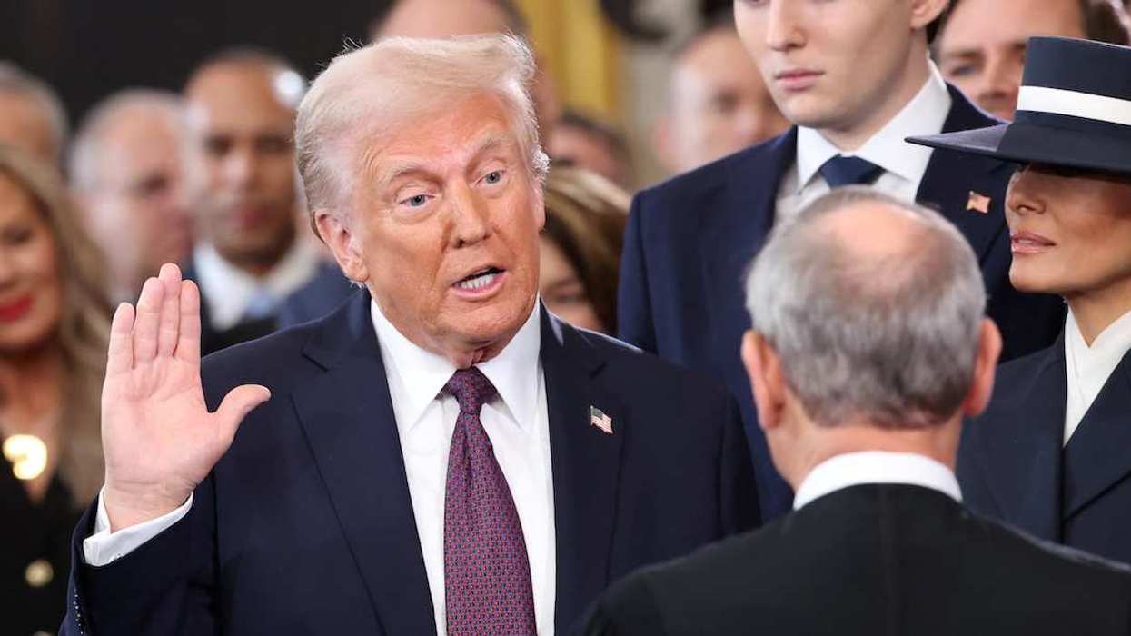 U.S. President Donald Trump takes oath as Barron Trump and Melania Trump look on the day of his Presidential Inauguration at the Rotunda of the U.S. Capitol in Washington, U.S., January 20, 2025.