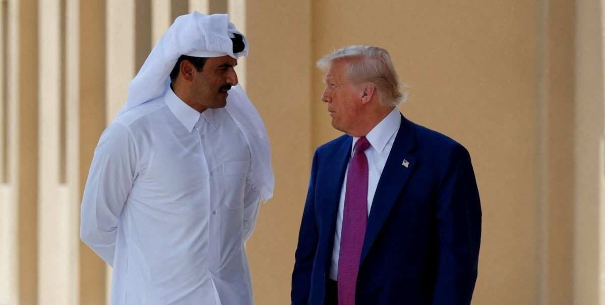 ​U.S. President Donald Trump talks with Qatar's Emir Tamim bin Hamad Al Thani in Doha, Qatar, May 15, 2025. 