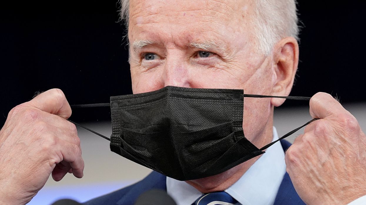 U.S. President Joe Biden removes his face mask prior to receiving his coronavirus disease (COVID-19) booster vaccination in the Eisenhower Executive Office Building's South Court Auditorium at the White House in Washington, U.S., September 27, 2021.