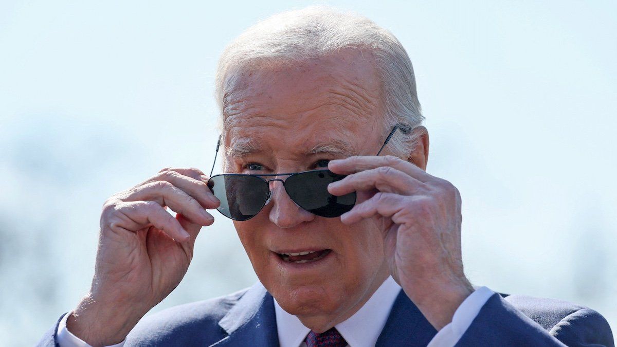 ​U.S. President Joe Biden removes his sunglasses before speaking to members of the news media before boarding Marine One for travel to California from the South Lawn of the White House in Washington, U.S., February 20, 2024. 