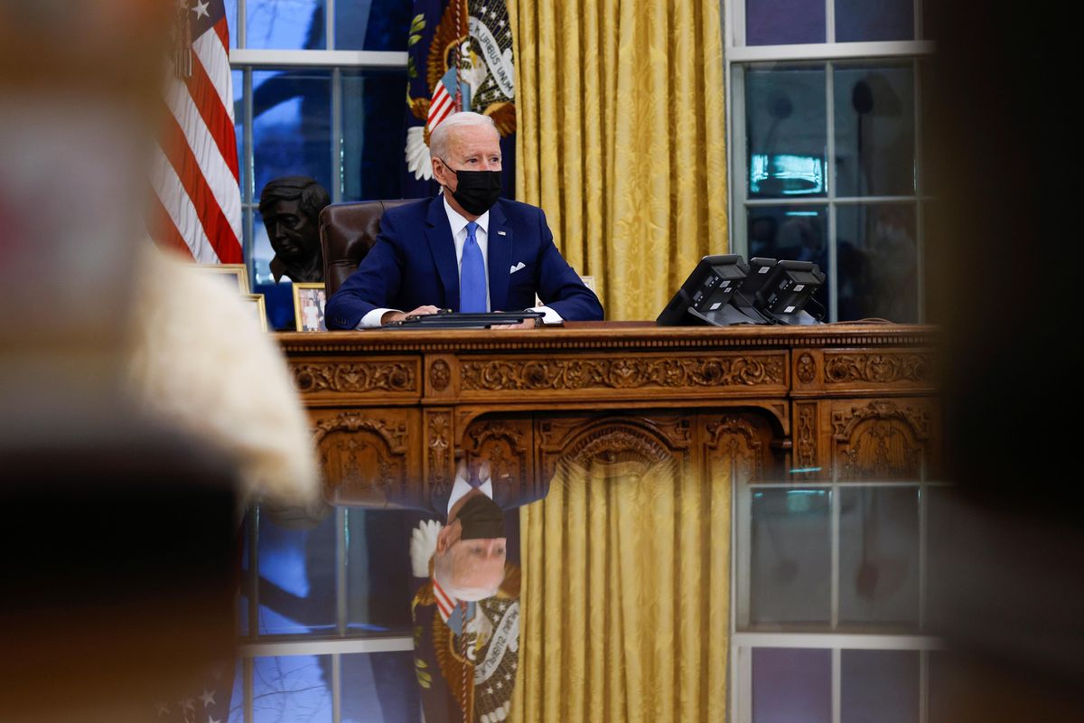 U.S. President Joe Biden signs executive orders on immigration reform inside the Oval Office at the White House in Washington, U.S., February 2, 2021. 