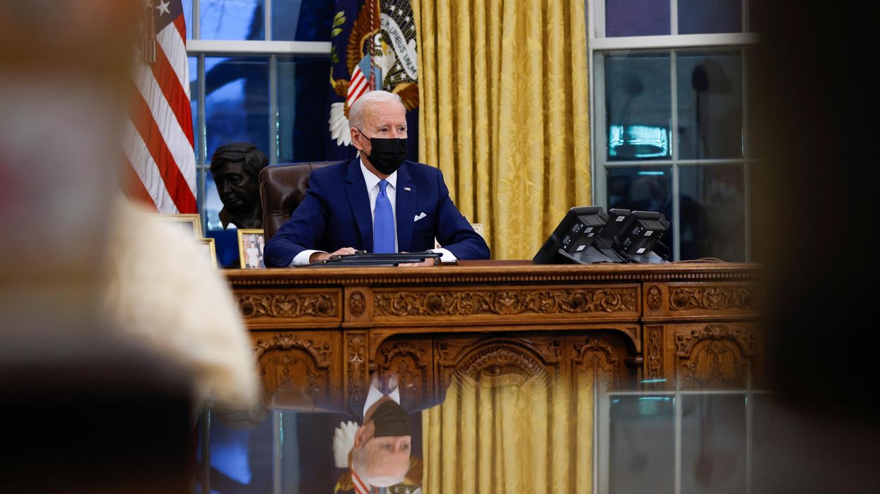 U.S. President Joe Biden signs executive orders on immigration reform inside the Oval Office at the White House in Washington, U.S., February 2, 2021.