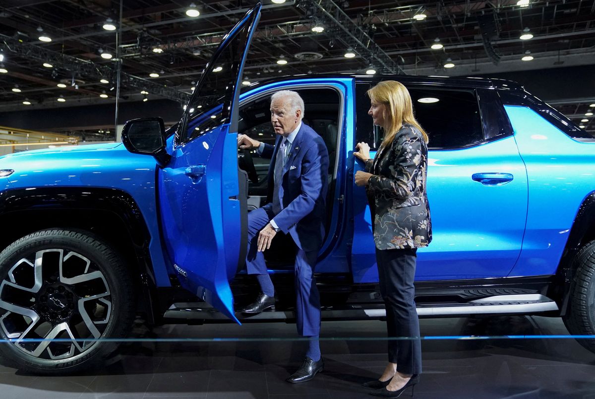 U.S. President Joe Biden steps out of an electric Chevrolet Silverado EV pickup truck being shown to him by General Motors Chief Executive Mary Barra during a visit to the Detroit Auto Show. 