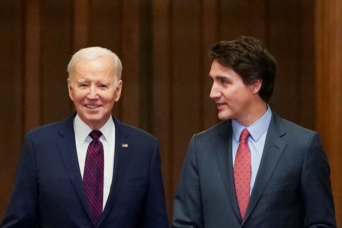 ​U.S. President Joe Biden walks with Canadian Prime Minister Justin Trudeau in Ottawa, Ontario, Canada March 24, 2023. 