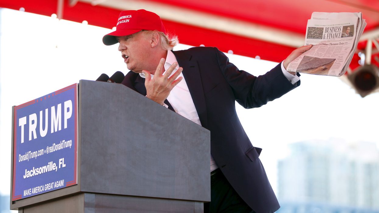 U.S. Republican presidential candidate Donald Trump holds a copy of the Wall Street Journal while speaking at a Trump for President campaign rally at the Jacksonsville Landing in Jacksonville, Florida.