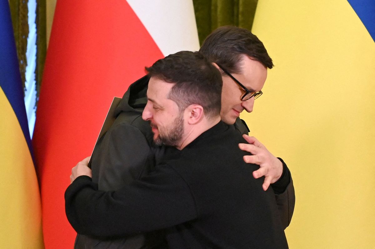 Ukraine's President Volodymyr Zelenskiy and Polish Prime Minister Mateusz Morawiecki embrace during a joint news briefing on a day of the first anniversary of Russia's attack on Ukraine, in Kyiv, Ukraine February 24, 2023.