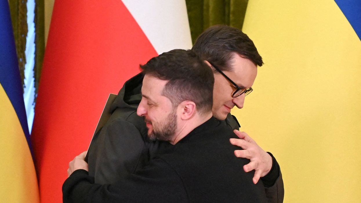 Ukraine's President Volodymyr Zelenskiy and Polish Prime Minister Mateusz Morawiecki embrace during a joint news briefing on a day of the first anniversary of Russia's attack on Ukraine, in Kyiv, Ukraine February 24, 2023.