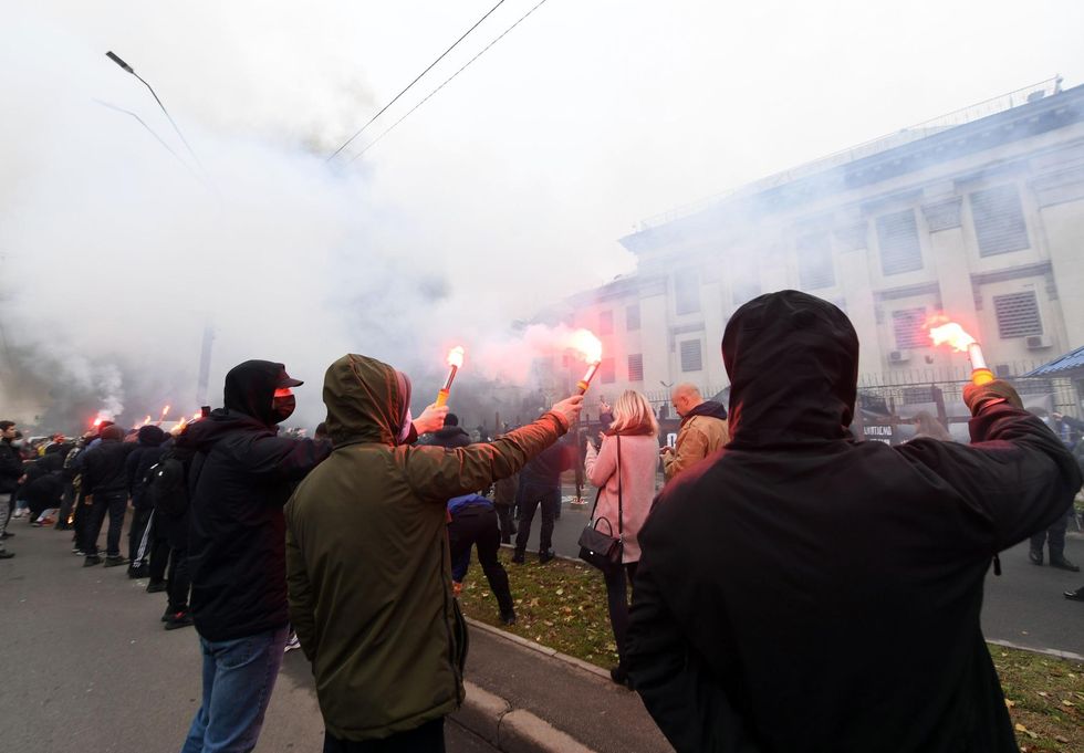 Ukrainian activists protest outside the Russian embassy in Kiev in 2020, during a protest called "You killed us then and continue to kill us now".