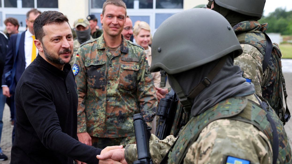 Ukrainian President Volodymyr Zelenskiy interacts with soldiers during his visit to a military training area to find out about the training of Ukrainian soldiers on the ?Patriot? anti-aircraft missile system, at an undisclosed location, in Germany, June 11, 2024.