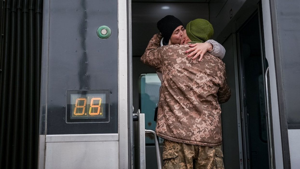 Ukrainian serviceman kisses his wife who was visiting him during a short break from his frontline duty, amid Russia’s attack on Ukraine, at the train station in Kramatorsk, Ukraine February 14, 2024.